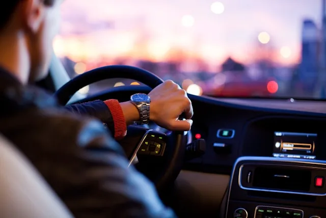 View from the back seat of a person driving a car.