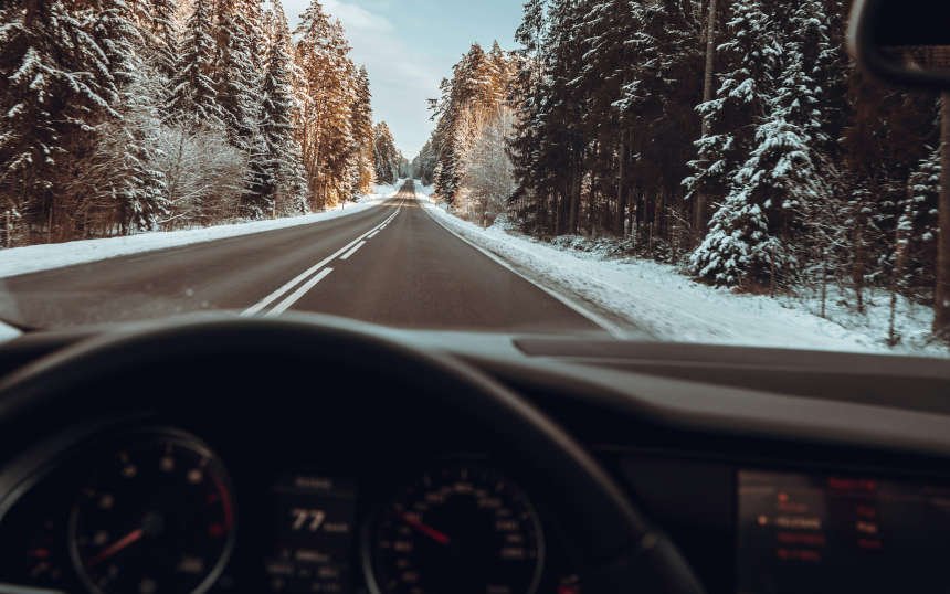 Interior view of a car driving in winter, highlighting the car's heating system, keeping the interior warm while the cold remains outside with our heating system repair in Nampa, ID.