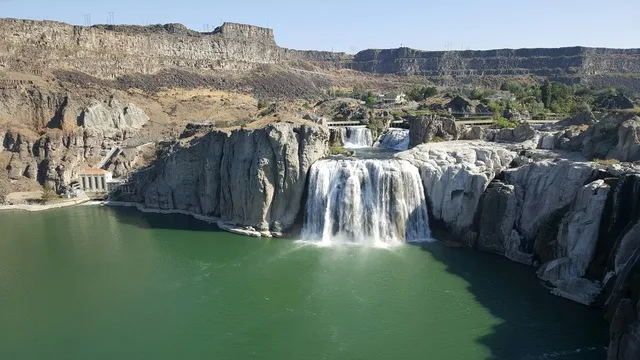 A breathtaking view of Shoshone Falls cascading over rocky cliffs into the Snake River.