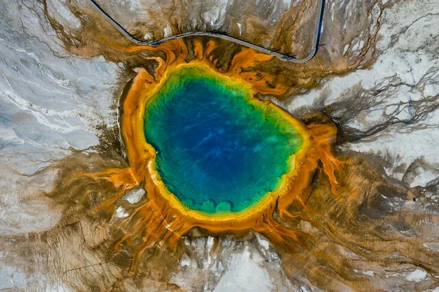 A vibrant hot spring with colorful mineral deposits at Yellowstone National Park.