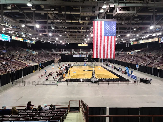 Ford Idaho Center Arena – Nampa, Idaho Interior view of Ford Idaho Center in Nampa during a basketball event, with large American flag and audience in the stands