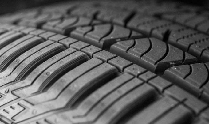 Close-up of a car tire tread showing detailed patterns for tire rotation.